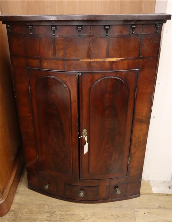 A George III mahogany hanging corner cabinet W.86cm